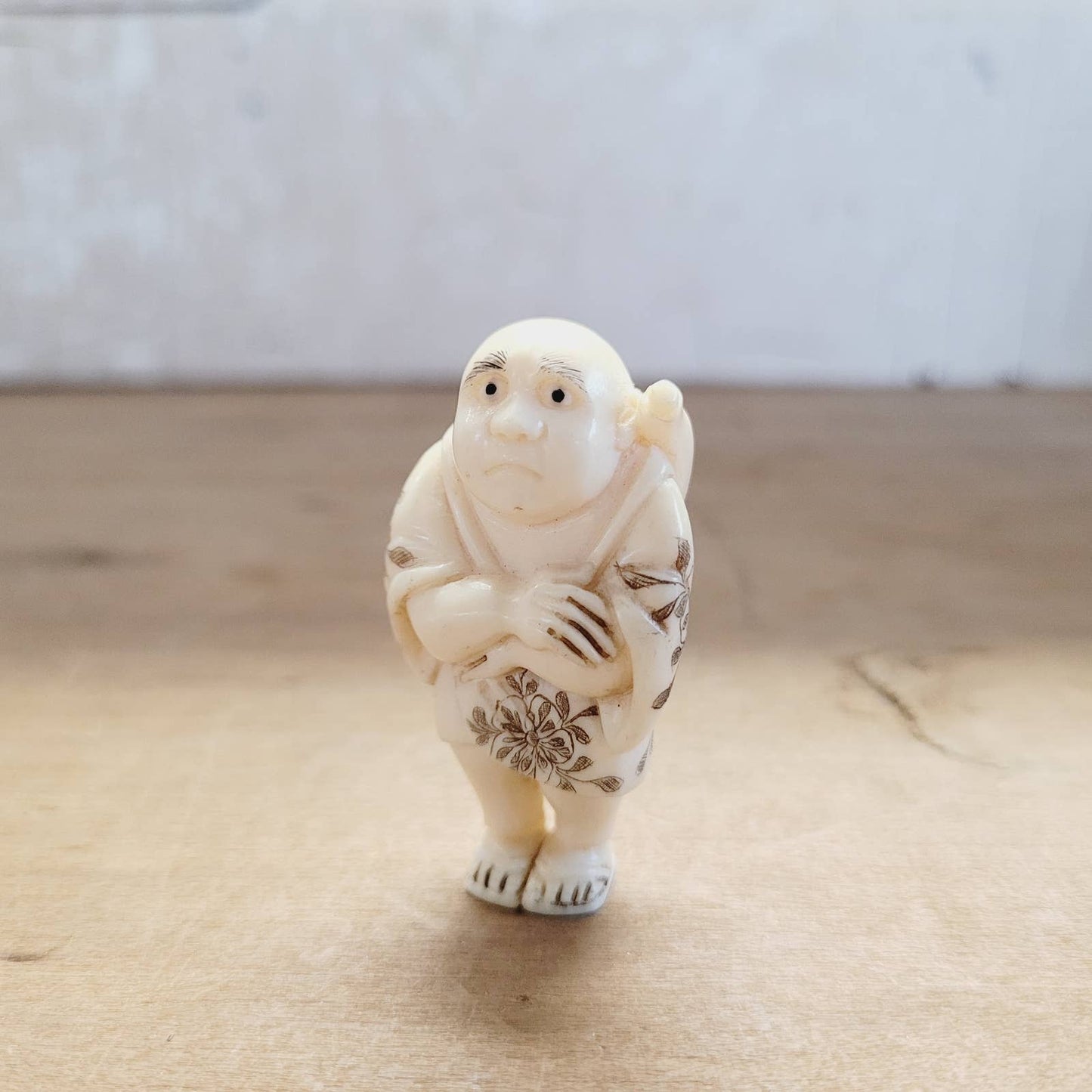 Japanese Antique Netsuke Sad Man with Flowers